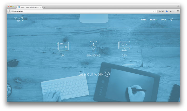 Underbelly.is - Screenshot of creative agency homepage, blue washed desktop, full screen background